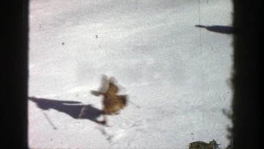 1961: two people skiing quickly down a snow-covered mountain ASPEN COLORADO