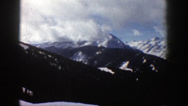 1961: snow covered mountains with pine trees ASPEN COLORADO