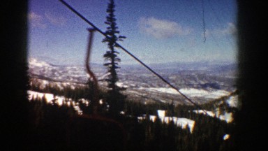 1961: riding the chair of a ski lift and viewing the surrounding valleys and