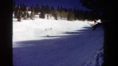 1961: party of 4 adults skiing downhill through a beautiful forest area ASPEN