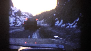 1961: a car rides behind a snow plow on an icy road ASPEN COLORADO
