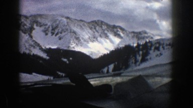 1961: the car moving around the full mist and snow mountain ASPEN COLORADO