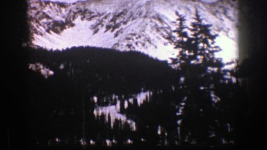 1961: vast area of mountains with snow and many pine trees ASPEN COLORADO