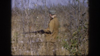 1958: A Hunter Walking Through Autumn Bushes in Kansas