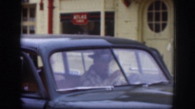 1958: Man in Black Hat and Companions Exiting Vintage Car in Kansas