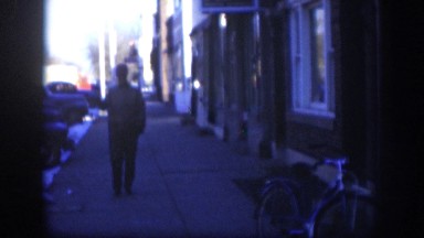 1958: man saluting with his cap walking on the town KANSAS