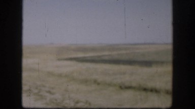 1958: road divides field which is smooth and wavy on one side and sharply angled