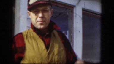 1958: Man Talking While Removing and Fixing Cap in Kansas