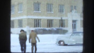 1958: Two People Walking on Roadside in Winter Kansas