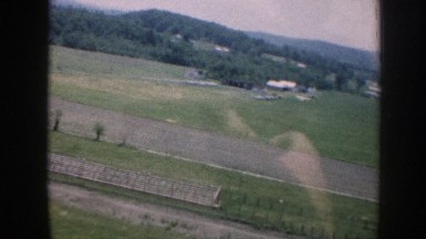 1958: view from an air vehicle of an open area surrounded by trees NEBRASKA