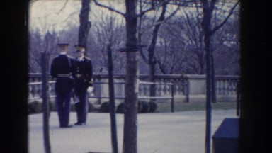 1960: archival footage of a couple of uniformed servicemen twirling rifles