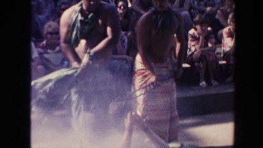 1961: two men in traditional dress cook an animal with his abdomen cut open