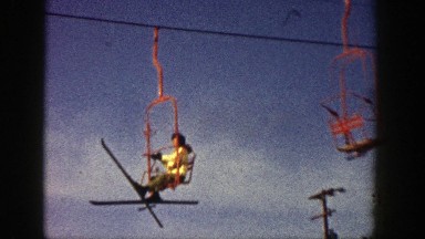 1961: Skater with Poles Sitting in Moving Rope Way Aspen Colorado