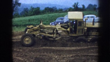 1958: Two Tractors Moving Soil in Nebraska Farm Field