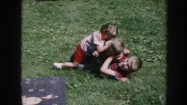 1958: Three Kids Playing in Open Grass Field Nebraska