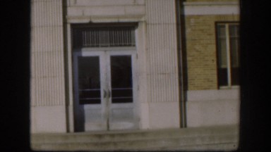 1958: a man walking out of a brick and marble building KANSAS