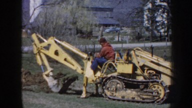 1958: Man Operating Tractor in Nebraska Field, Digging Dirt, 8mm Home Movie