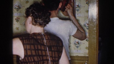 1958: teen boy combing his hair, following by man operating a powered vehicle to