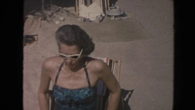 1961: Old Man and His Wife Entertaining on a Beach in Hawaii