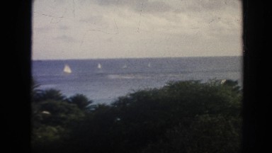 1961: sailboats in the ocean and buildings by the water HAWAII
