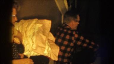 1959: family patiently sitting around the living room during a blackout in their