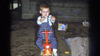 1959: smiling child playing on a red horse NEBRASKA