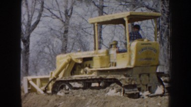 1959: bulldozer pushing dirt with the blade and a waiting dump truck NEBRASKA