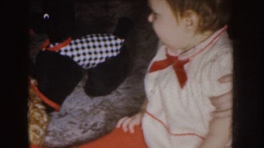 1955: a baby sitting on a carpet turns off a candle on a cake NEBRASKA