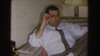 1955: a man sitting on sofa and doing smoking with confusing mind NEBRASKA