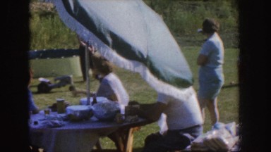 1955: family sitting outside on windy day NEBRASKA