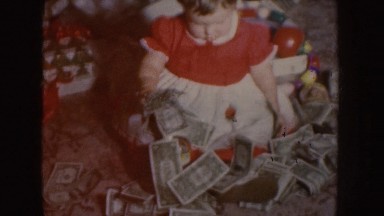 1955: a toddler surrounded by dollars and toys NEBRASKA