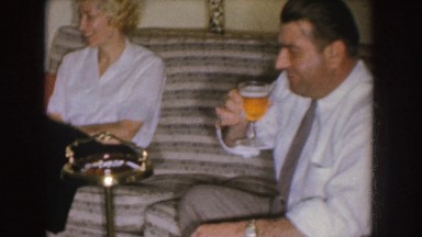 1955: couple having a friendly discussion with another man while enjoying