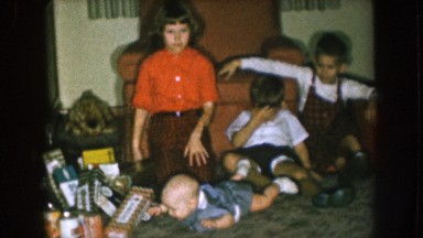 1957: kids are playing with a small baby lying on the floor NEBRASKA