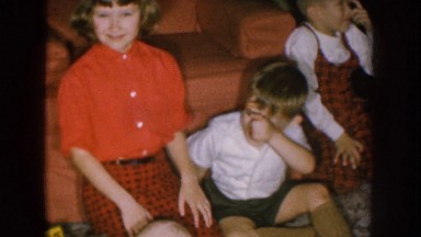 1957: a child, two toddlers and a baby on the floor in a living room near the