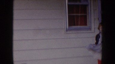 1957: girl in a dress wearing red tights, dancing and swinging her dress on the