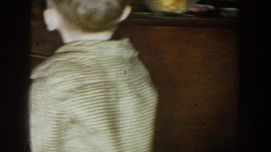1957: a small blonde boy grabs a treat from a glass dish NEBRASKA