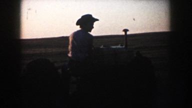 1953: man on tractor backing it into the camera SOUTH DAKOTA