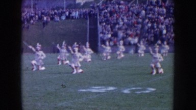 1957: cheerleaders and a band performing at a football game NEBRASKA