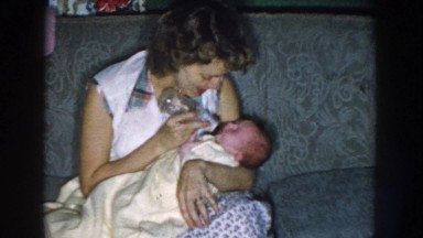 1959: mother feeding her child with love. NEBRASKA