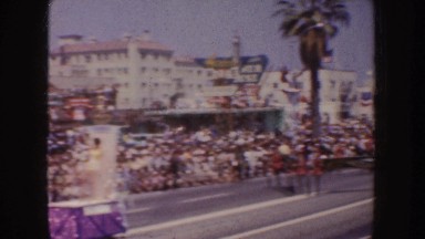 1952: people watching parade as it makes its way down a major city street.