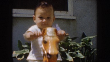 1952: toddler plays on old-fashioned rocking horse CALIFORNIA