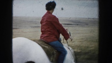 1953: woman riding a white horse in a plain. SOUTH DAKOTA