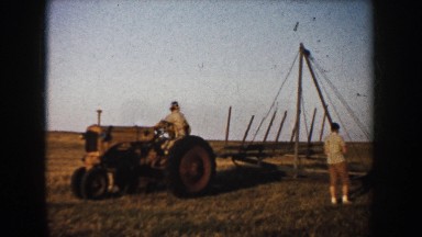 1953: group of people in a rural area in the process of starting the