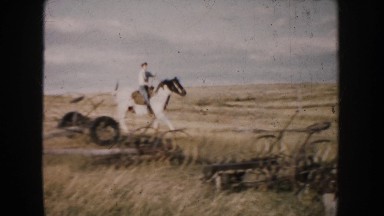 1953: A Woman Riding a Horse Through a North Dakota Prairie Farm