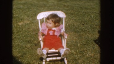 1955: toddler rocking in miniature rocking chair NEBRASKA