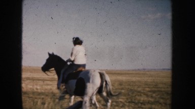 1953: Woman Riding White Horse in Field, South Dakota