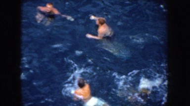 1952: Six Men Swimming in Blue Water, California