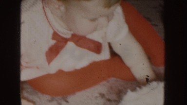 1955: A Baby Dressed in Red Sitting in Front of a White Frosted Cake Nebraska