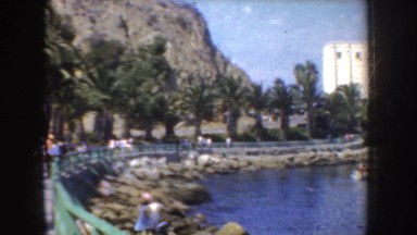 1952: by the water, luxury hotel with boats next to it. CALIFORNIA