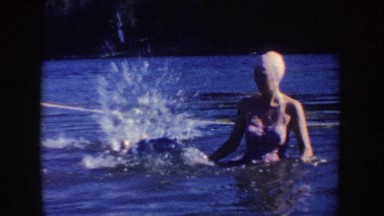 1954: two women swimming in a lake with one doing handstands SOUTH DAKOTA